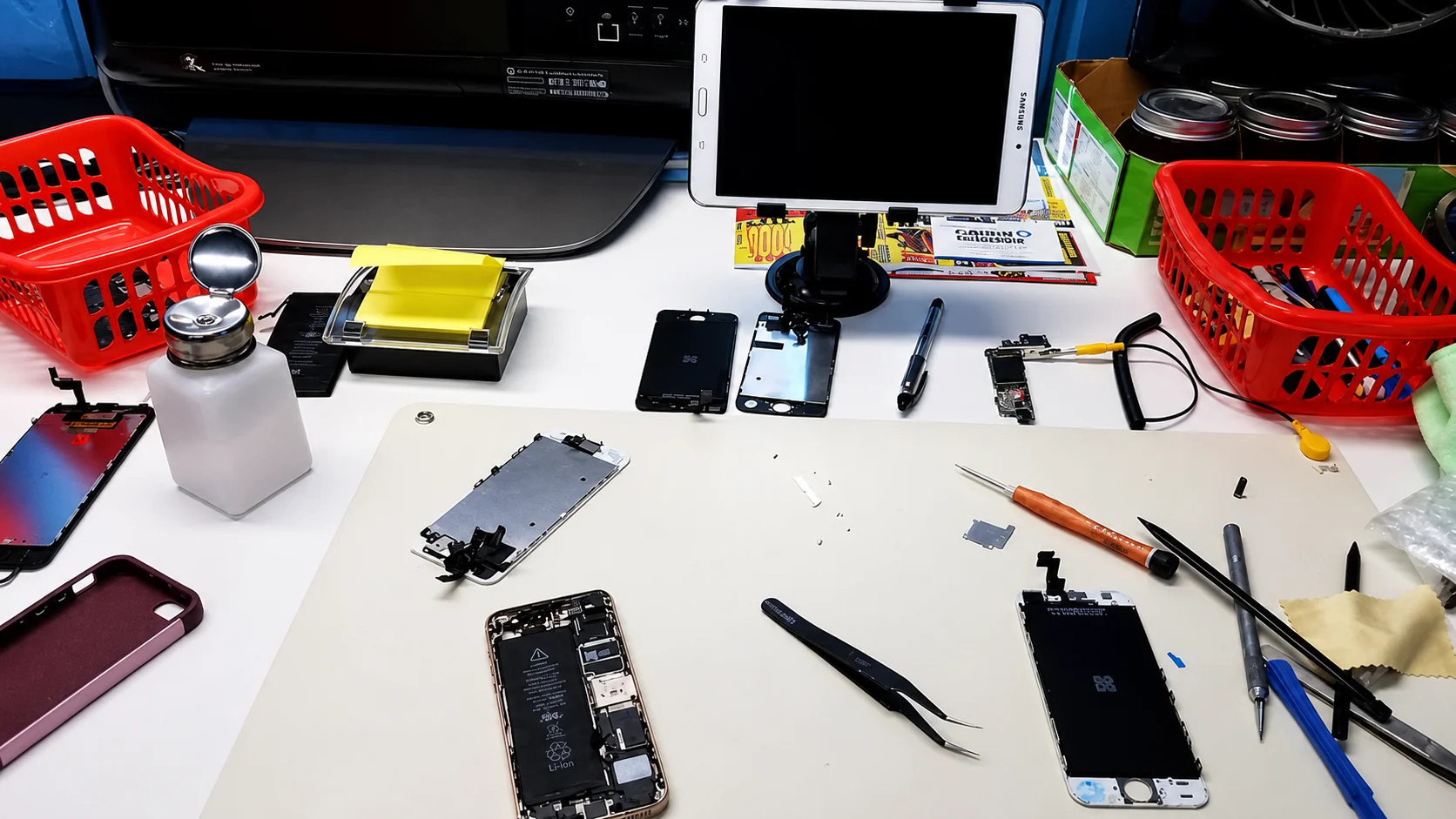 Phone and tablet disassembled into parts during a repair