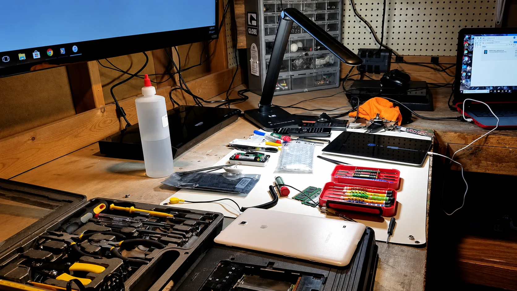 Tablet repair tools laid out on the workbench