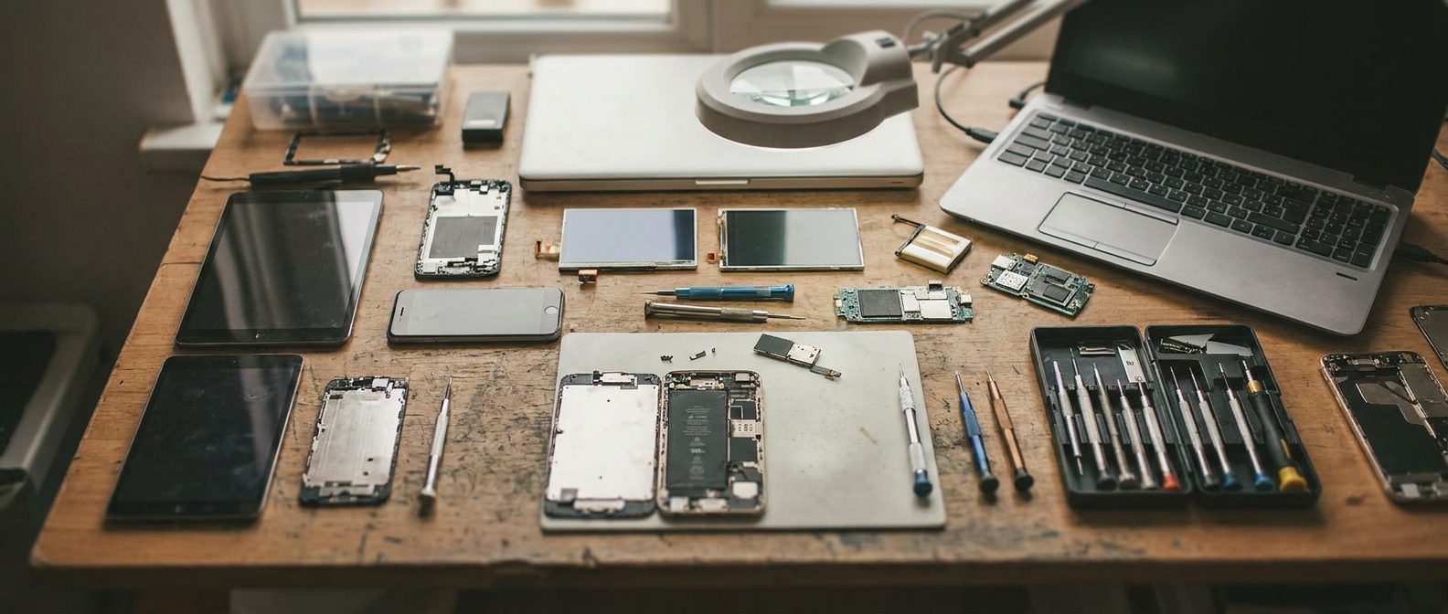 Repair bench with tools and an opened smartphone