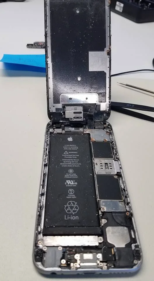 iPhone battery being replaced at the repair bench